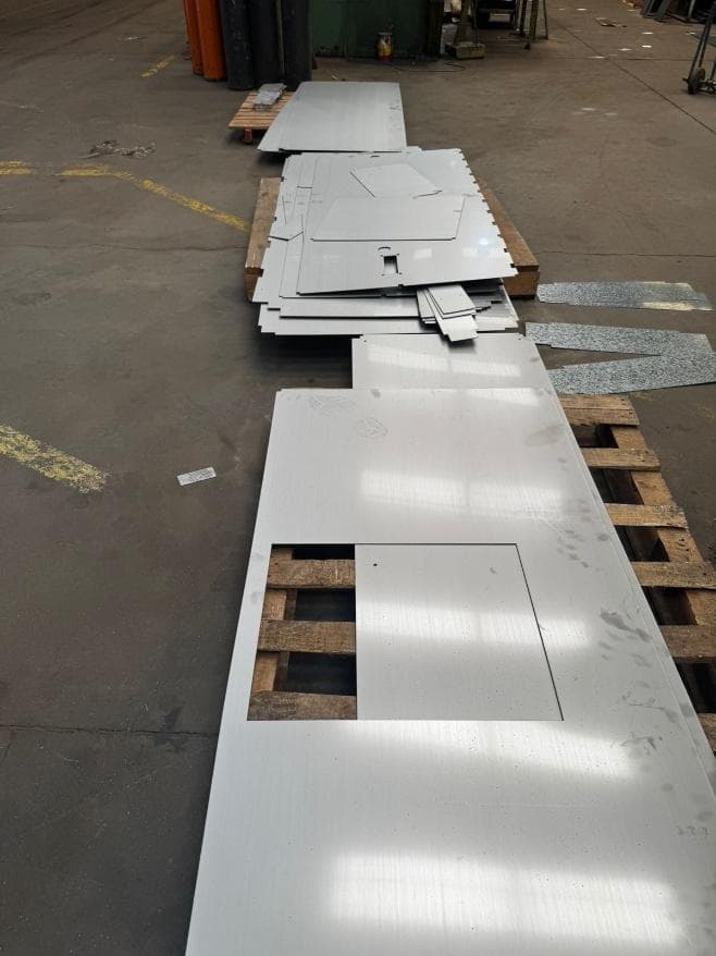 Cut sheet steel stacked on pallets in the workshop