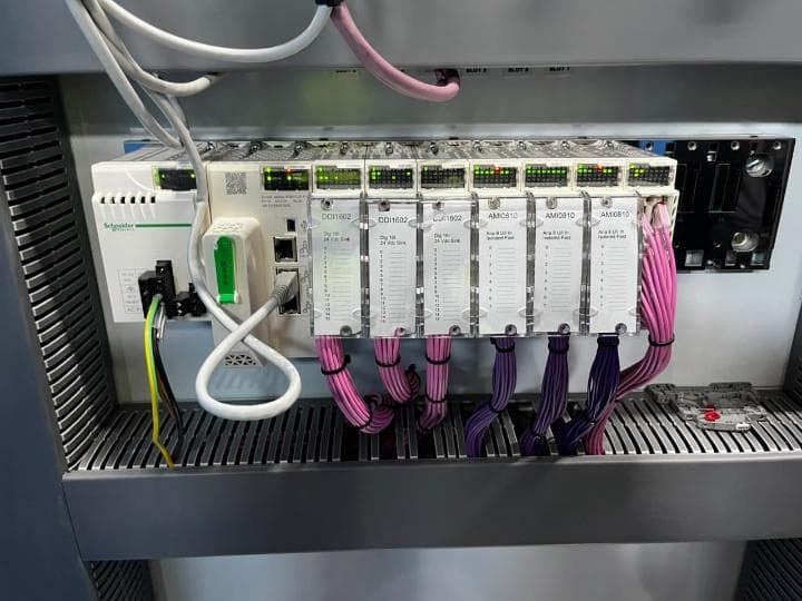 Schneider PLC rack with I/O modules and colour-coded wiring